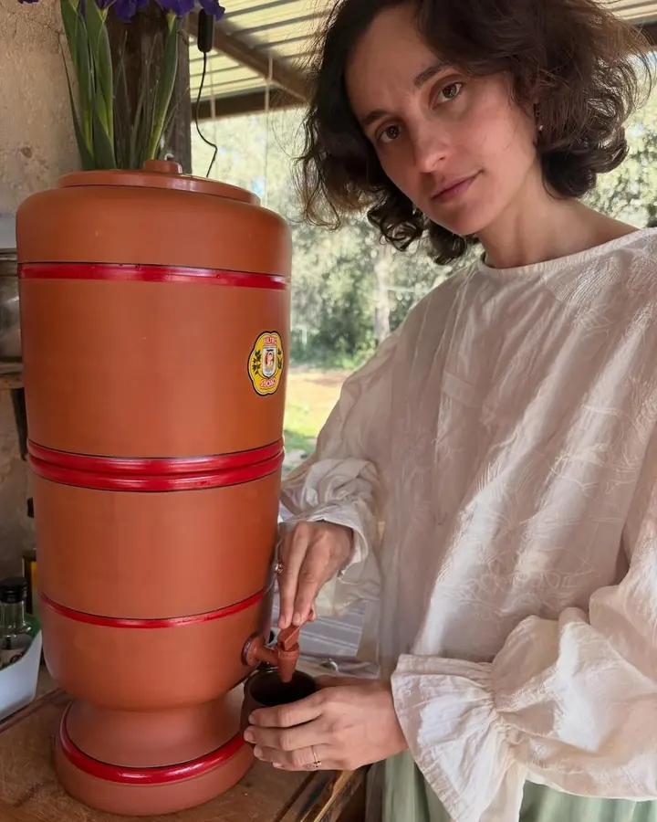 ema in her kitchen, turning towards the camera